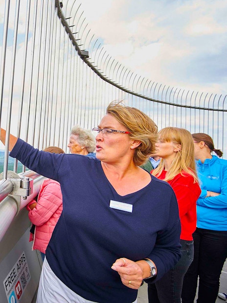Visitors on the observation deck of Fernsehturm Stuttgart, overlooking the cityscape.