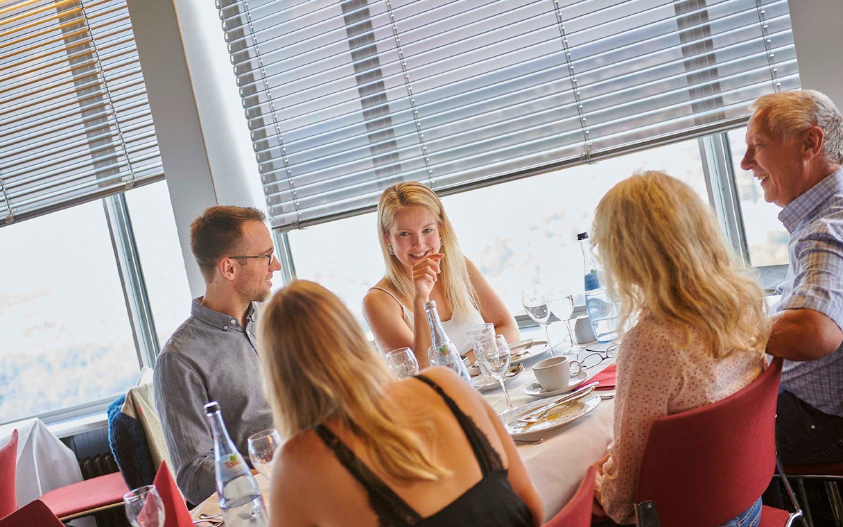 Dining experience at Fernsehturm Stuttgart with a group enjoying a meal.