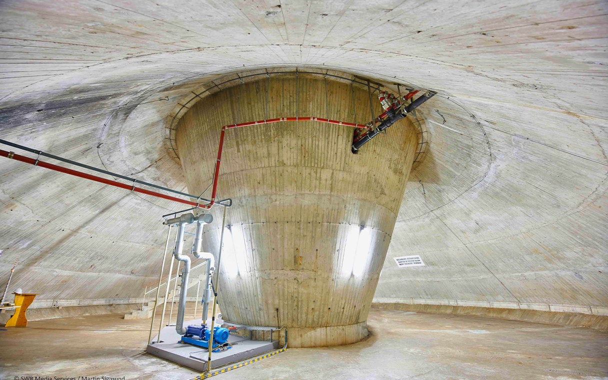 Interior view of the Fernsehturm Stuttgart structure with visible pipes and machinery.