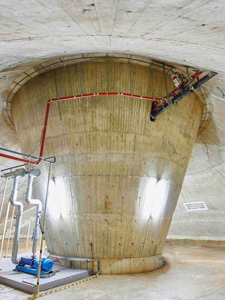 Interior view of the Fernsehturm Stuttgart structure with visible pipes and machinery.