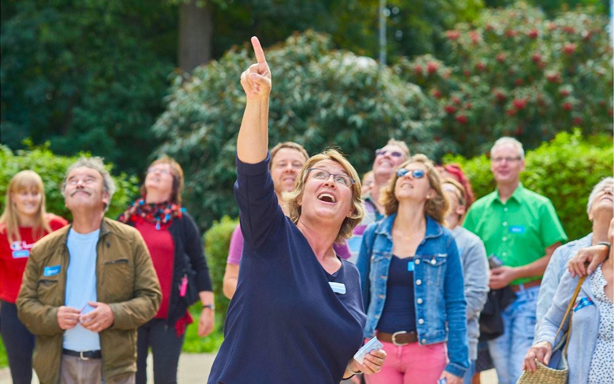 Group of tourists looking up at the Fernsehturm Stuttgart.
