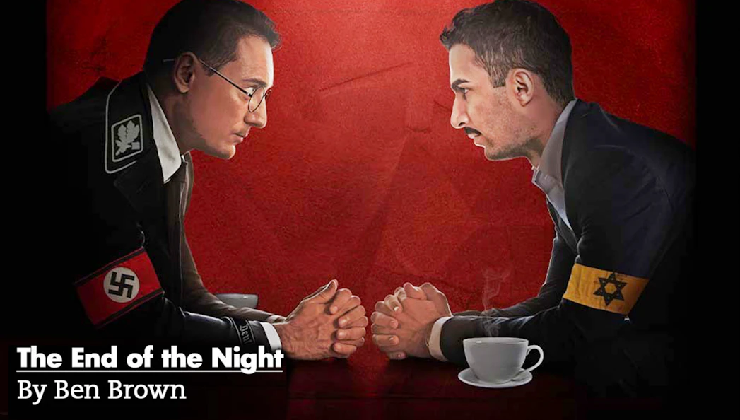 Two men facing each other over a table, one with a Nazi armband, the other with a Star of David armband.