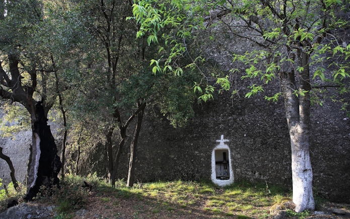 Hidden shrine in forest along Meteora hiking trail, Greece.