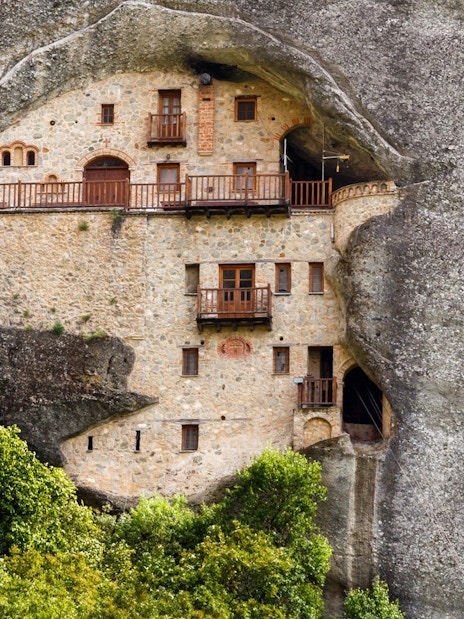 Monastery built into rock face on Hidden Trails of Meteora Hiking Tour, Greece.
