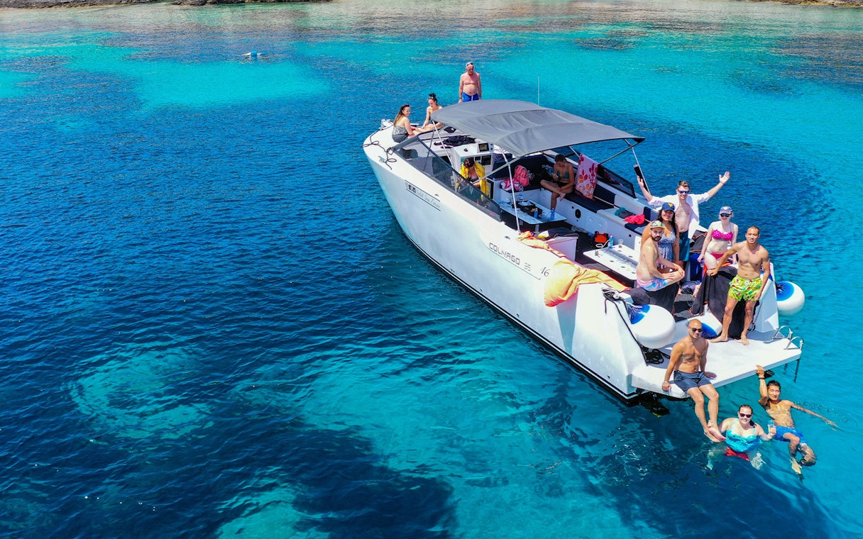 Boat tour group enjoying clear waters near Split, Croatia.