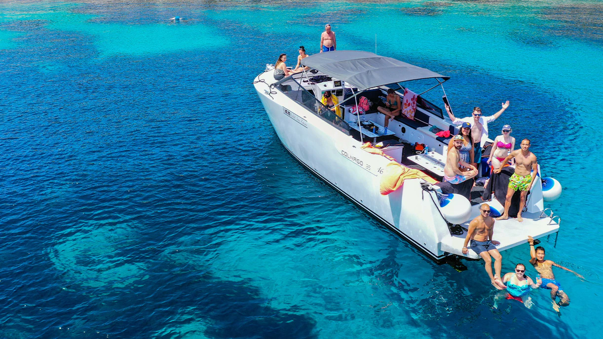 Boat tour group enjoying clear waters near Split, Croatia.