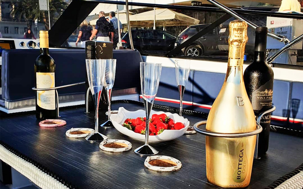 Champagne and strawberries on a boat deck during Split's Blue Cave, Vis, and Hvar tour.