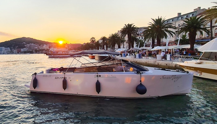 Boat docked at Split harbor at sunset, starting point for Blue Cave, Vis, and Hvar tour.