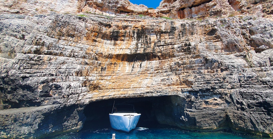 Boat entering Blue Cave on Vis Island, Croatia during a full-day tour from Split.