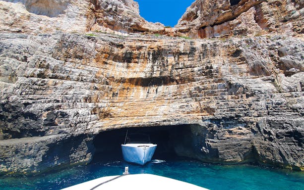 Boat entering Blue Cave on Vis Island, Croatia during a full-day tour from Split.