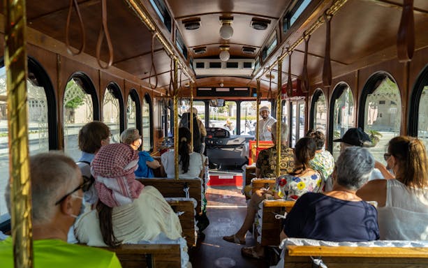 Tourists seated inside a vintage trolley bus during the Culture on Wheels tour.