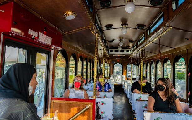 Guests on a traditional Emirati trolley for a hospitality dining experience.