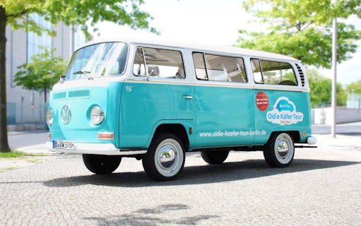 VW van for 4-hour Berlin tour parked on cobblestone street.