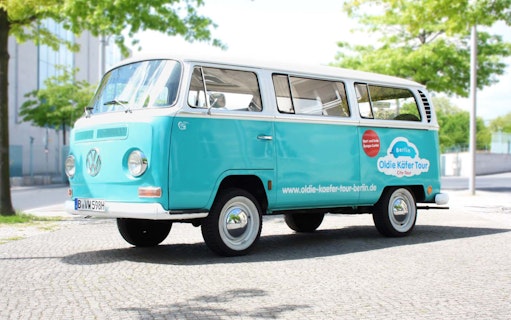 VW van for 4-hour Berlin tour parked on cobblestone street.