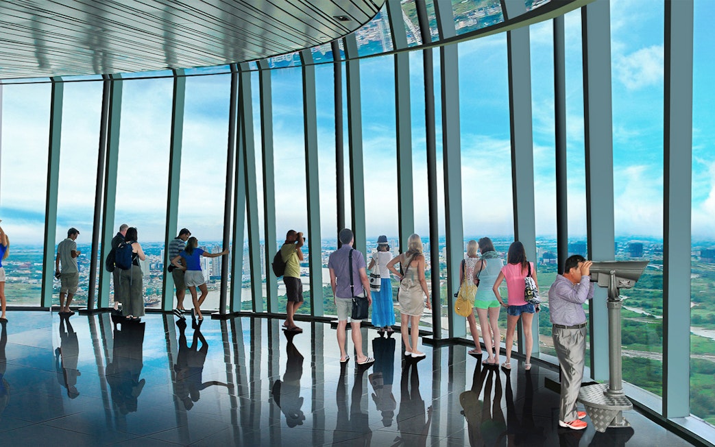 Visitors enjoying panoramic views from Saigon Skydeck in Bitexco Financial Tower.