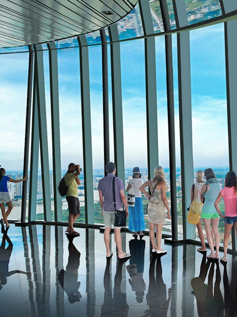 Visitors enjoying panoramic views from Saigon Skydeck in Bitexco Financial Tower.