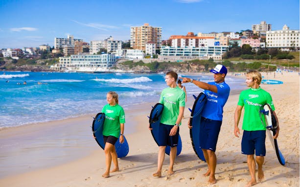 Surf instructor guiding students on Bondi Beach during a 2-hour surf lesson.