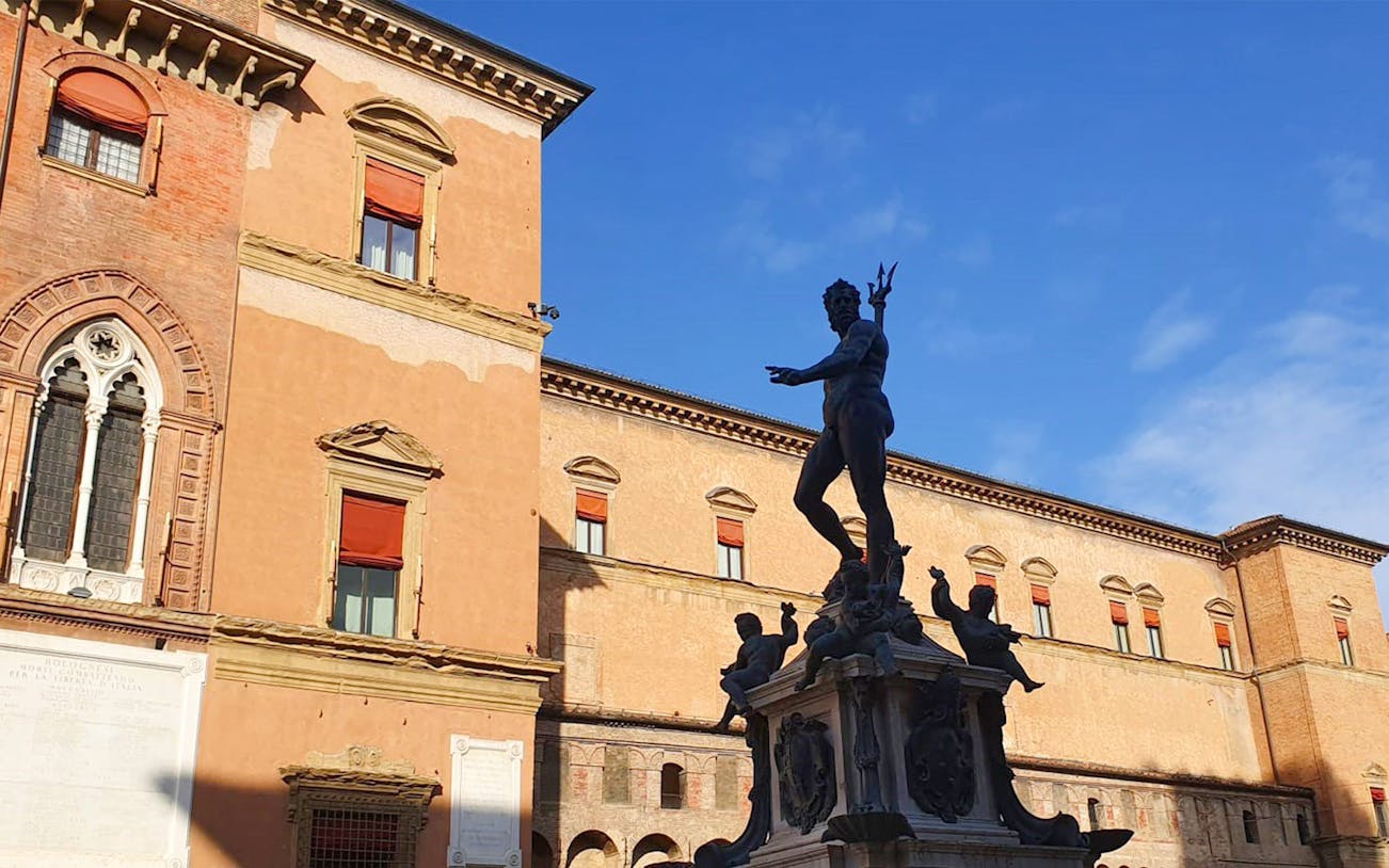 Neptune Fountain in Bologna's Piazza del Nettuno during a walking tour.