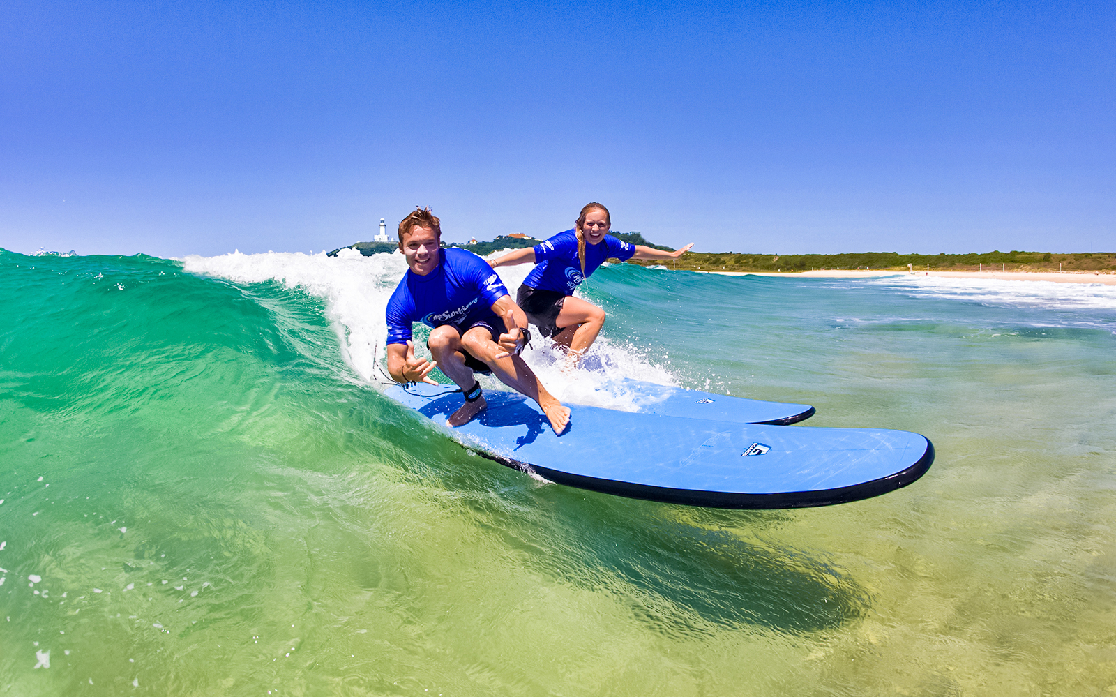 Surfers riding a wave during a lesson at Maroubra Beach, Sydney.