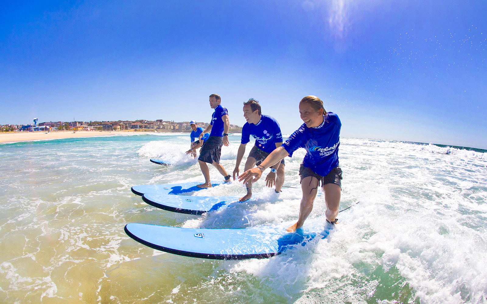 Surfers learning to ride waves during a lesson at Maroubra Beach, Sydney.