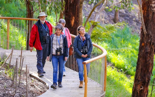 Visitors walking on a boardwalk during the Walk with Wildlife Guided Tour at Wildlife Wonders.
