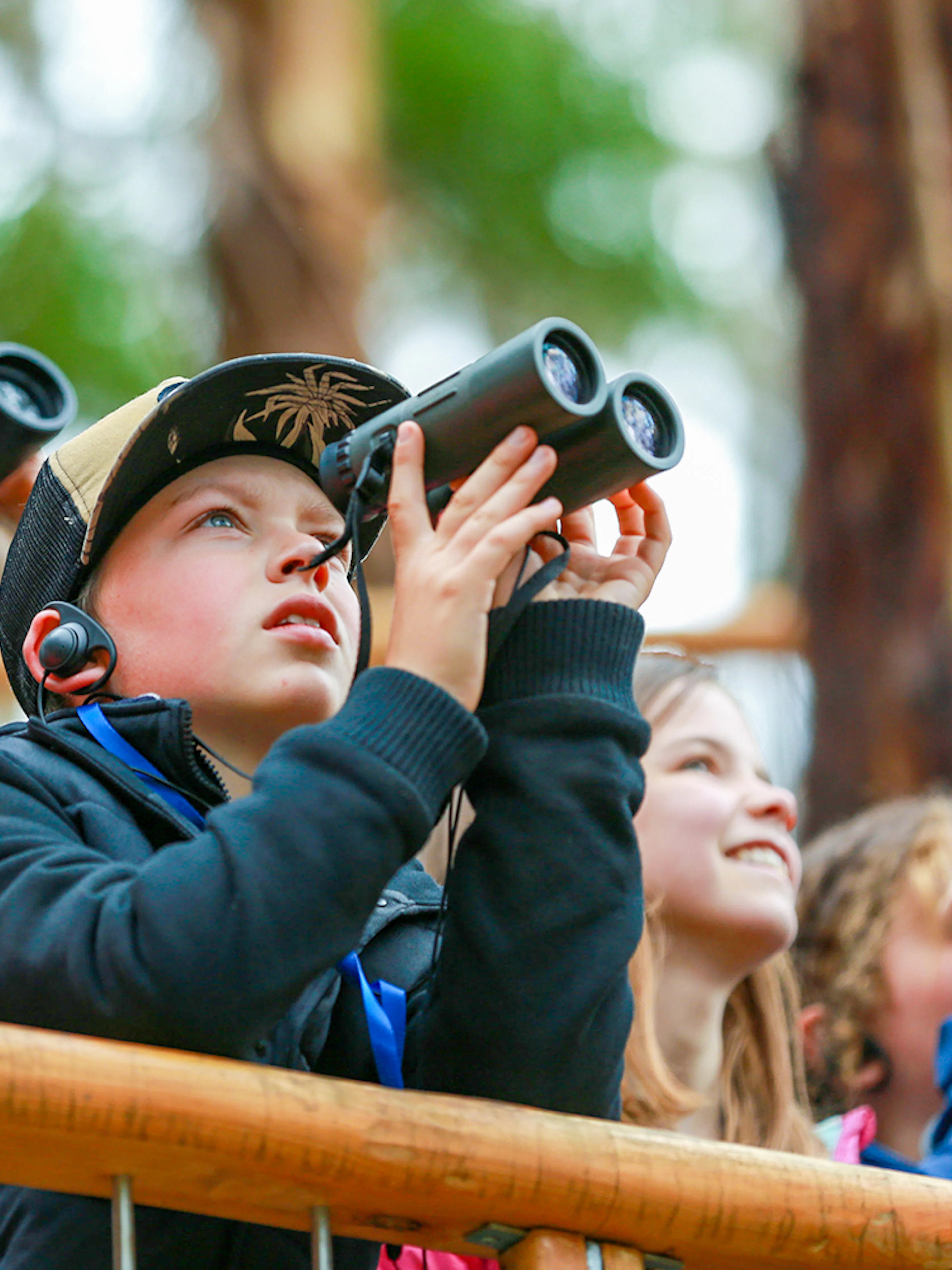 Group of people using binoculars on Walk with Wildlife Guided Tour at Wildlife Wonders.