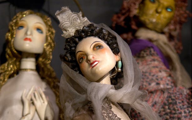 Three theatrical puppets on display at the Theatre Museum.
