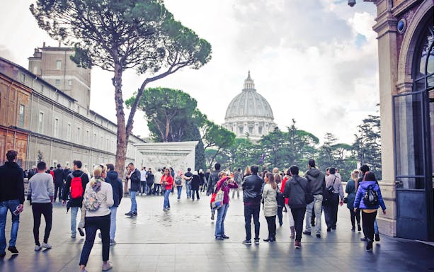 Visitors walking near St. Peter's Basilica in Vatican City, part of the Full Rome Pass tour.