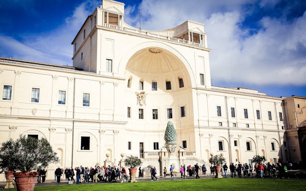 Vatican Museums courtyard with tourists, Rome.