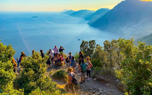 Hikers on the Path of the Gods trail overlooking the Amalfi Coast, Italy.