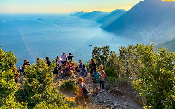 Hikers on the Path of the Gods trail overlooking the Amalfi Coast, Italy.