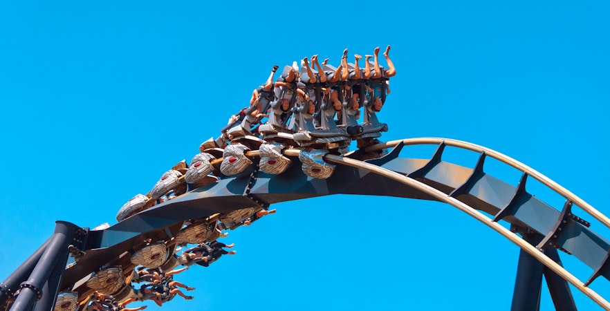 Roller coaster loop with riders at Mirabilandia theme park.