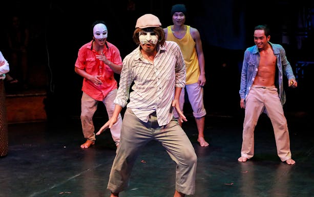 Performers in colorful costumes and masks at Phare, The Cambodian Circus.
