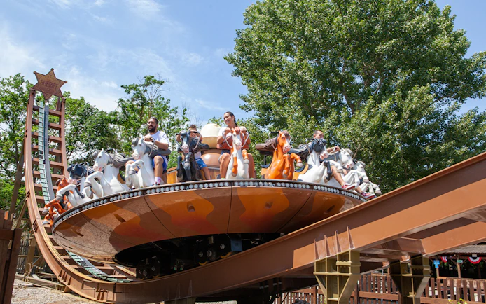 Visitors enjoying a spinning ride at Mirabilandia amusement park.