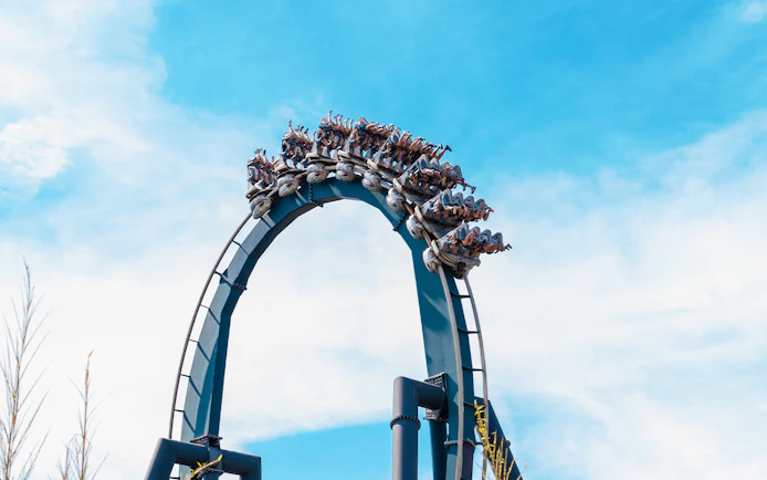 Roller coaster loop with riders at Mirabilandia, Italy.