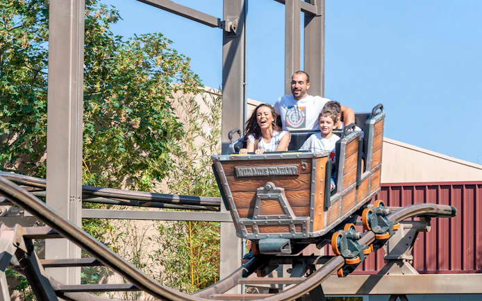 Family enjoying a roller coaster ride at Mirabilandia theme park.