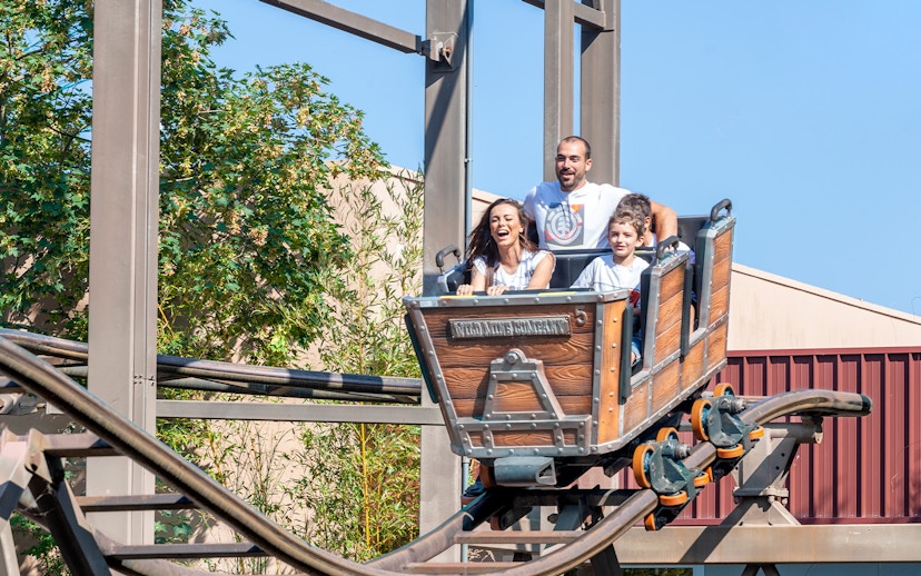 Family enjoying a roller coaster ride at Mirabilandia theme park.