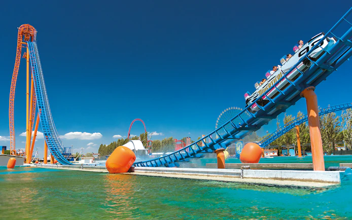 Roller coaster at Mirabilandia theme park, Italy, with water ride at Mirabeach.