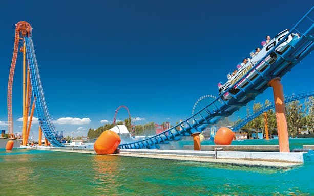 Roller coaster at Mirabilandia theme park, Italy, with water ride at Mirabeach.