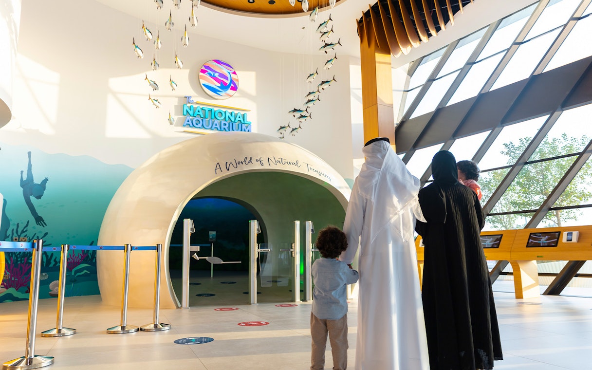 Visitors entering the National Aquarium Abu Dhabi through the main entrance.