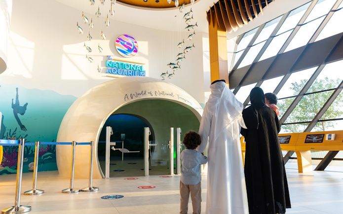 Visitors entering the National Aquarium Abu Dhabi through the main entrance.