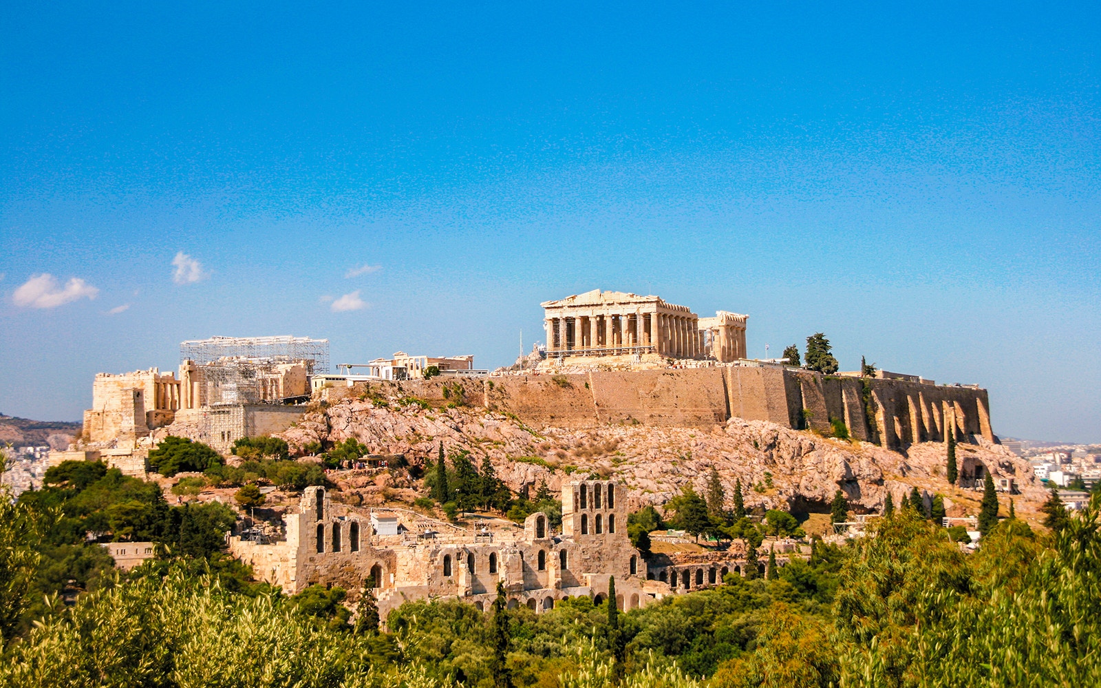 Acropolis of Athens with Parthenon under clear blue sky during morning tour.