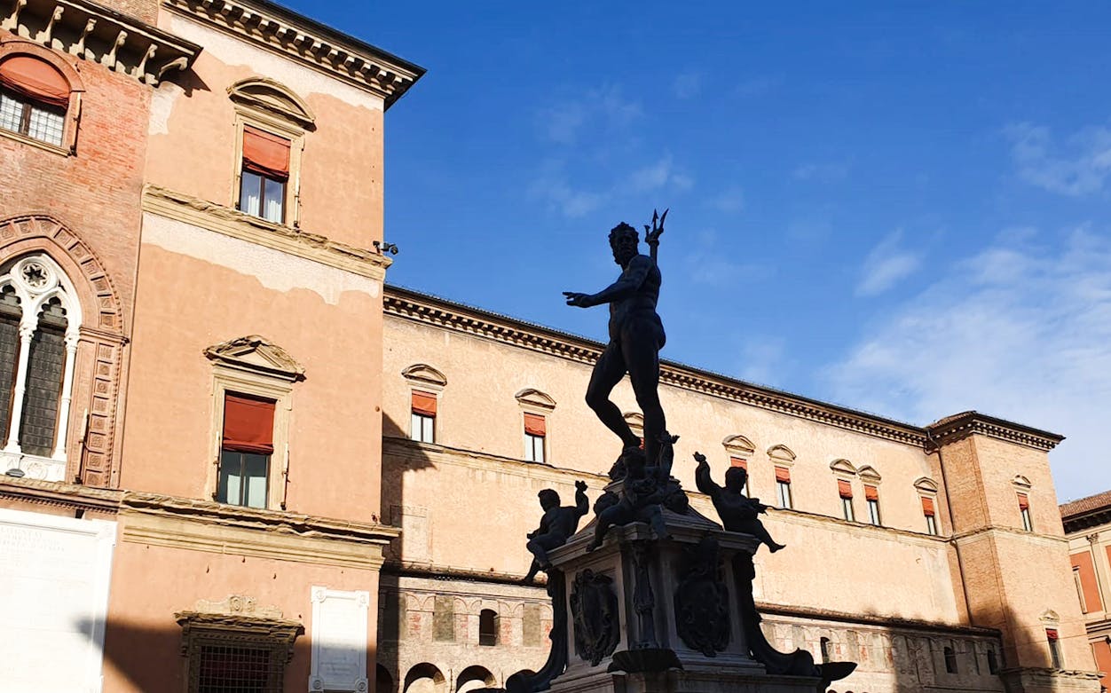 Neptune Fountain in Bologna's Piazza Maggiore during a musical walking tour.