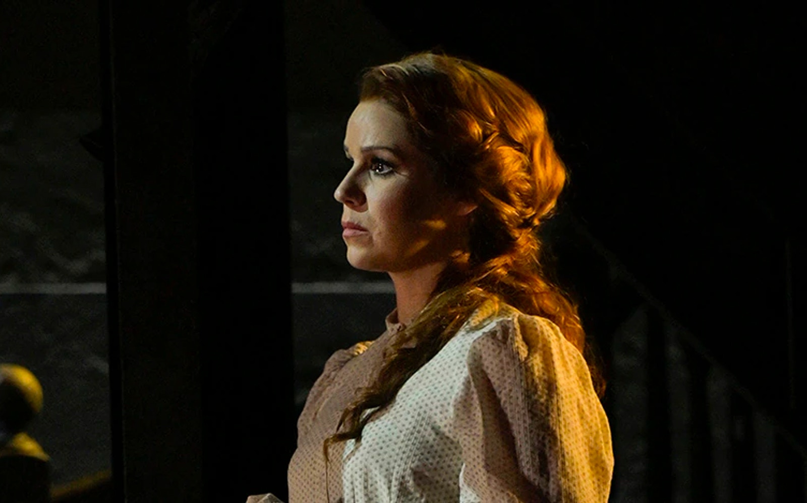 A person in period costume gazing thoughtfully, related to Paradise Square.