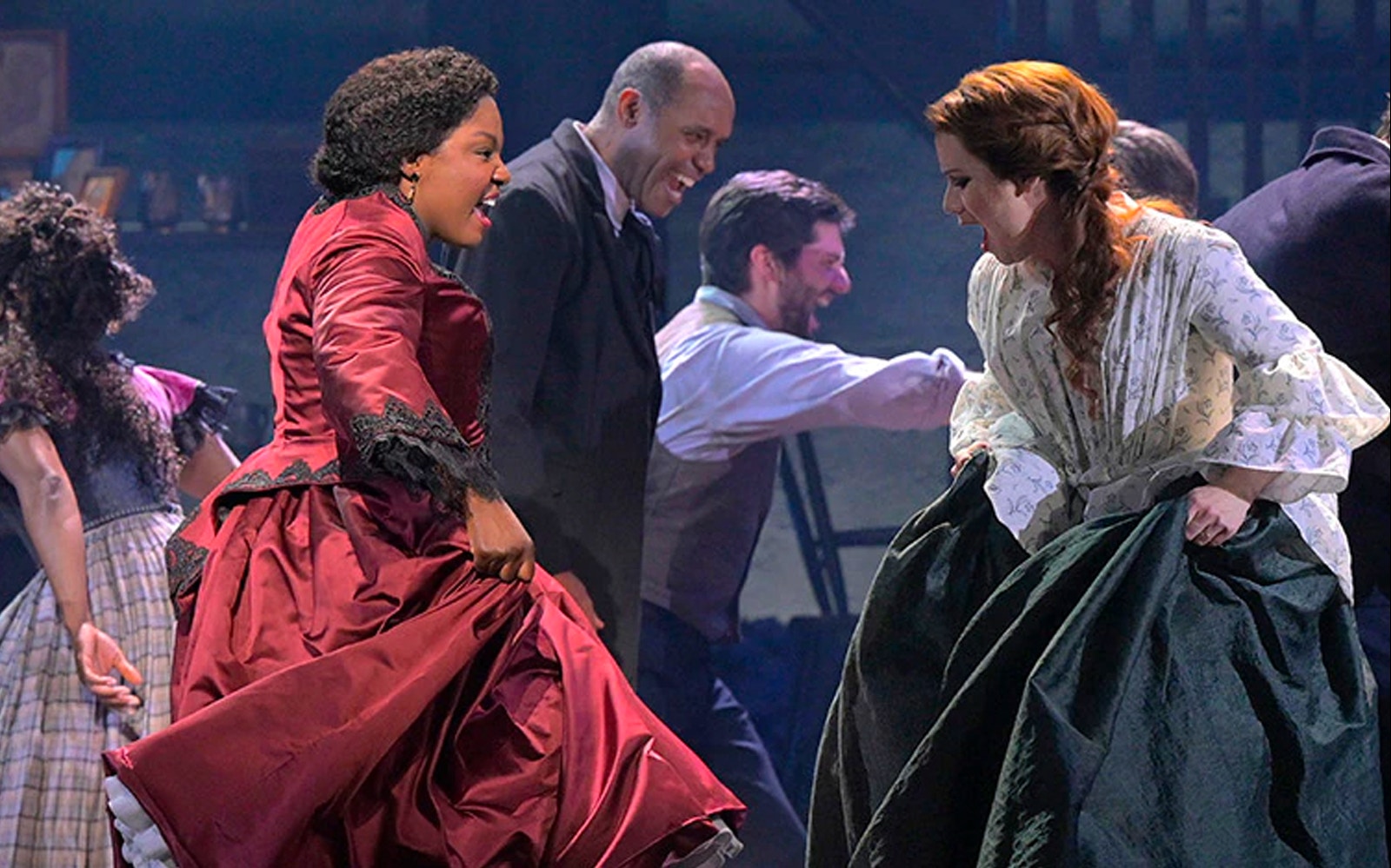 Performers dancing energetically in period costumes during a scene from Paradise Square.