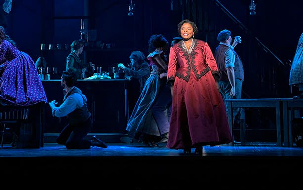 Stage performance at Paradise Square with actors in period costumes.