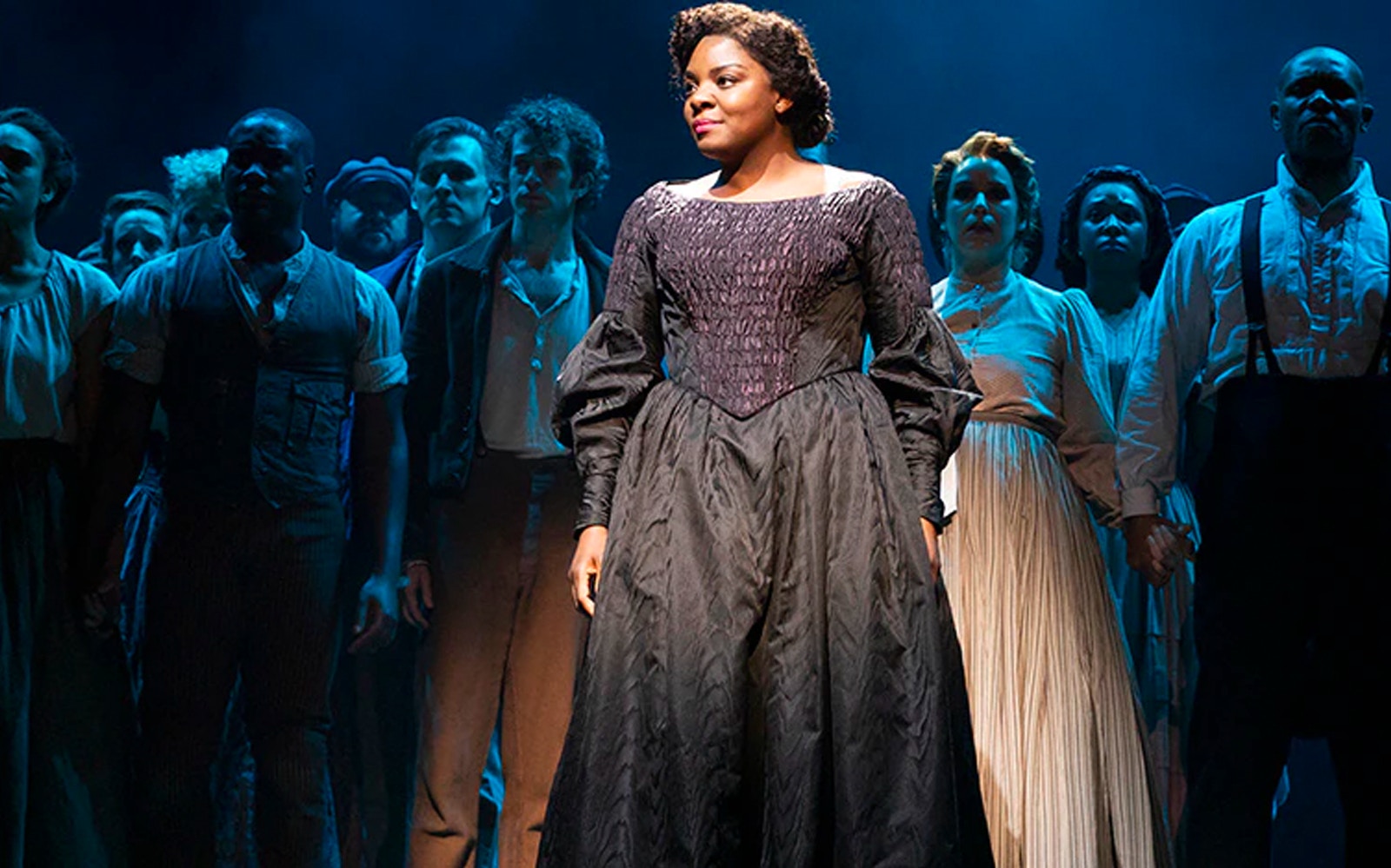 Cast performing on stage in Paradise Square musical.