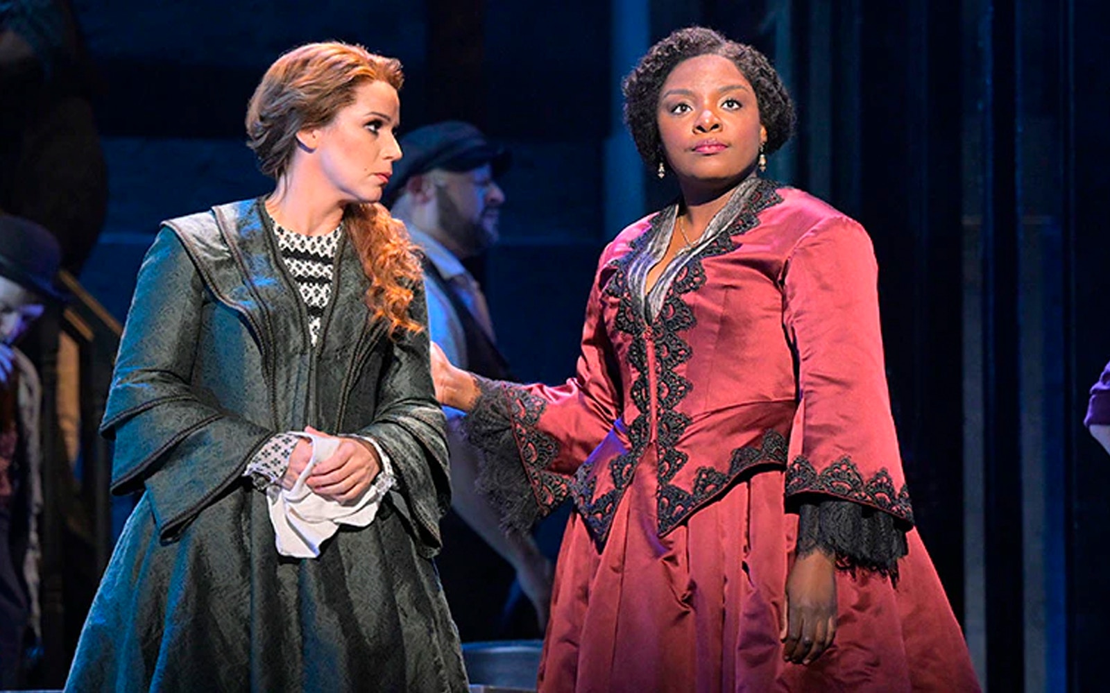 Two actors in period costumes performing a scene from Paradise Square.