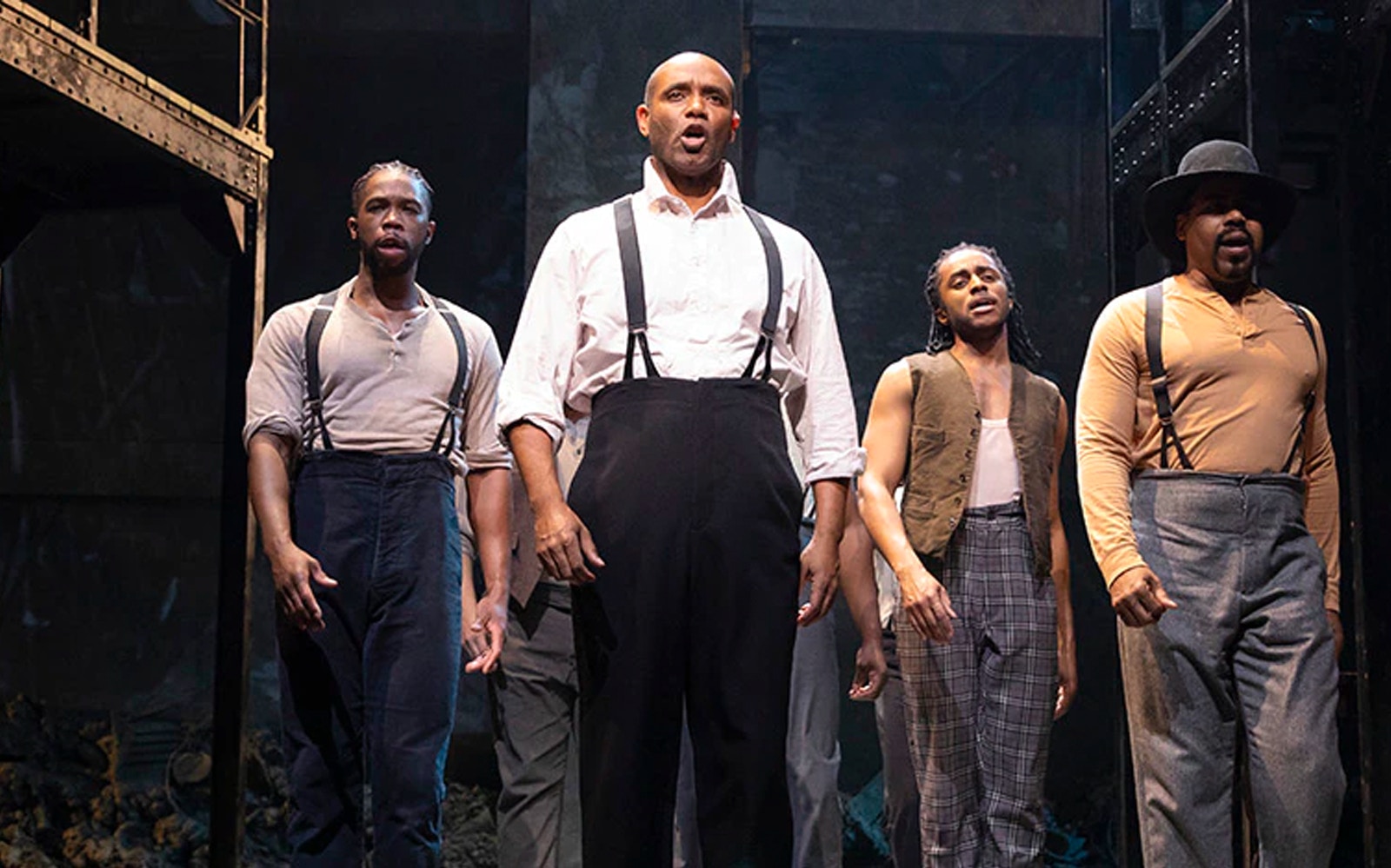 Performers on stage in a scene from Paradise Square musical.