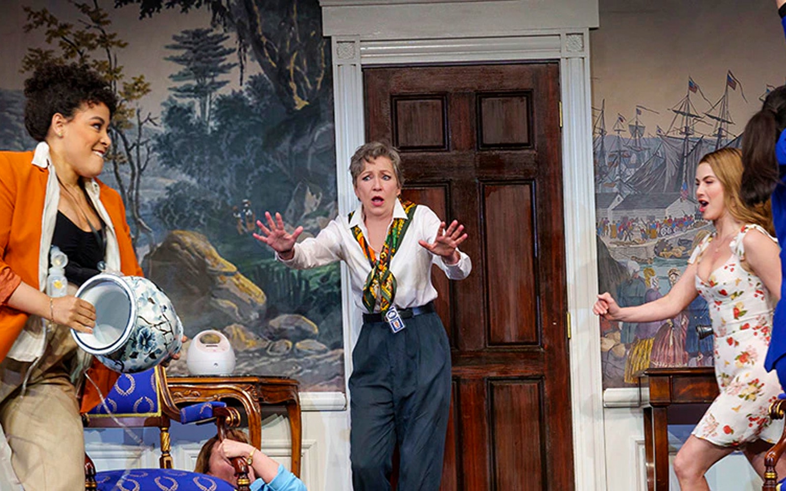 Women in a comedic scene from "POTUS" play, with one holding a vase and another reacting.